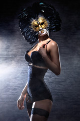 A young woman in erotic lingerie and a Venetian mask © Acronym