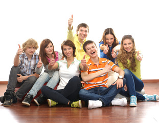 A group of young and happy teenagers sitting together