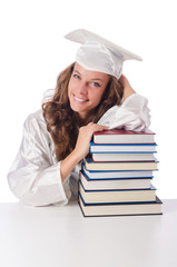 Happy graduate with lots of books on white