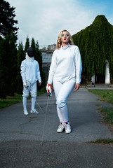 young couple in fencing costumes