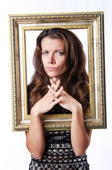 Young woman with picture frame on white