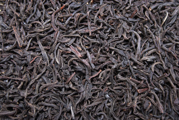 Black leaves tea background, food ingredient texture
