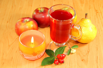 Still life - red tea, candles and fruits
