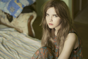 Fototapeta premium beautiful girl sitting on a bed