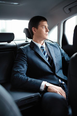 Fototapeta na wymiar Businessman in a car