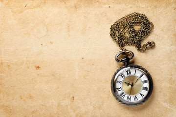 Vintage pocket watch on old paper