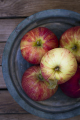 Fresh red apples on metal vintage plate