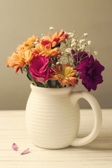 Beautiful flower bouquet on white wooden tabletop