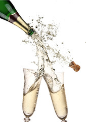 Pair of champagne flutes making a Champagne splash
