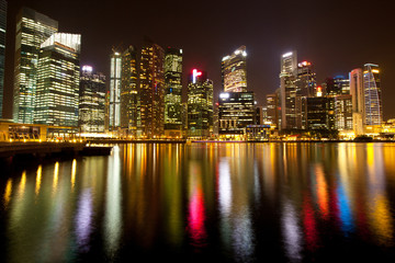 Fototapeta na wymiar A view of Singapore district in night with water reflections.