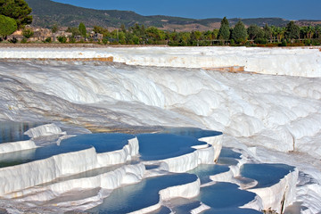 Travetine covered hills and rock pools of Pamukkale Turkey