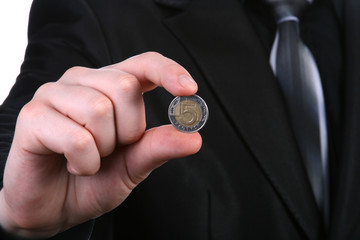 Businessman holding a coin 5 pln - obrazy, fototapety, plakaty