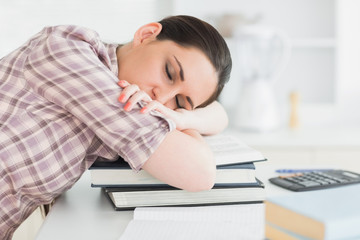 Woman asleep on books