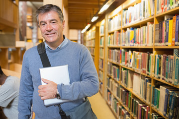 Man holding a book to his chest