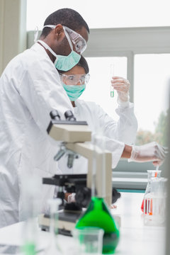 Chemists viewing liquids