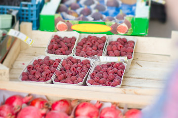 Small boxes with raspberry on street market