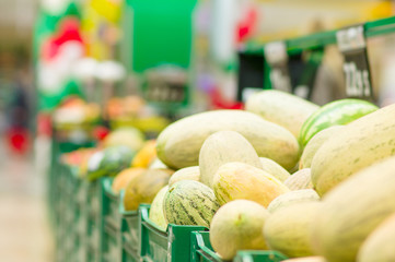 Variety of melons in boxes in supermarket