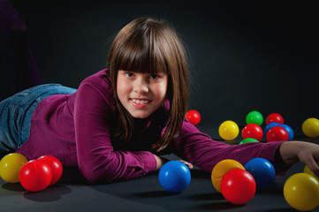 Fototapeta na wymiar cheerful girl with colored balls