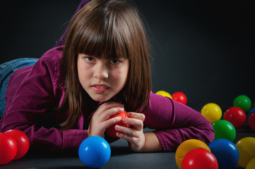 Fototapeta na wymiar cheerful girl with colored balls