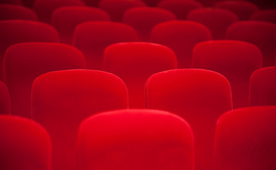 Red chairs in the empty auditorium