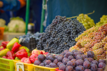 Plums, apples and grapes on city market