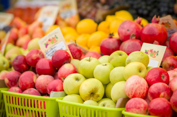 Red and green apples and fruits on city market