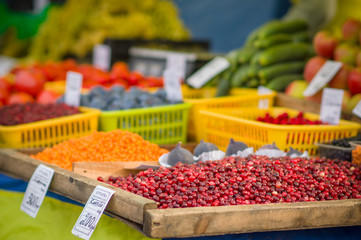 Variety of wild berries on table on city market