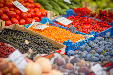 Variety of wild berries on table on city market