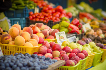 Variety of apples and peaches on city market