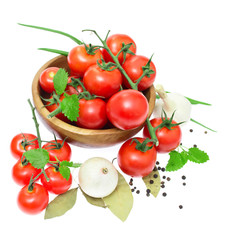 The branch of cherry tomatoes in a wooden bowl, onion, garlic, b