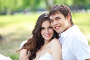 Fototapeta premium Young love Couple smiling under blue sky