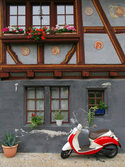 Trendy moped against old building. Fribourg, Switzerland