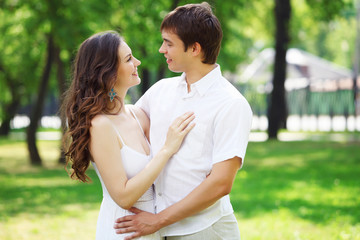 Fototapeta premium Young love Couple smiling under blue sky