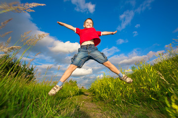 boy jumping against the blue sky