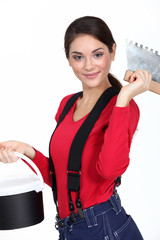 Female plasterer holding tool