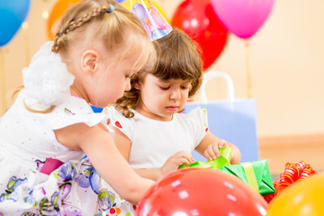 Fototapeta na wymiar pretty children with colorful balloons and gifts on birthday par