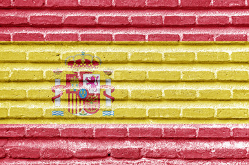Spanish flag on an old brick wall