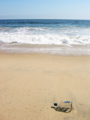 Empty bottle in ocean surf