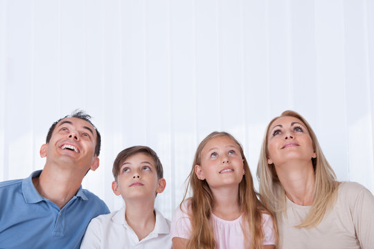 Portrait Of  Family With Two Children Looking Up