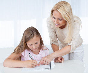 Mother Helping Her Daughter With Homework
