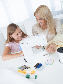 Beautiful Young Girl Sewing With Her Mother
