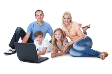 Happy Family With Two Children Using Laptop