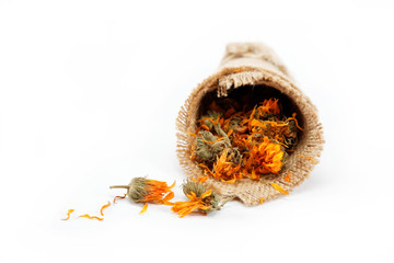 Herbs. Dried calendula or pot marigold flowers in a linen packag