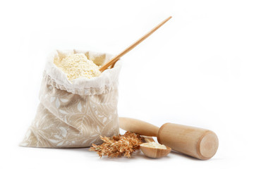 Fototapeta na wymiar Corn flour in a bag with wooden spoon and ear on white backgroun
