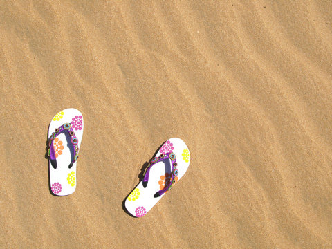 Trendy flip-flops on the sand