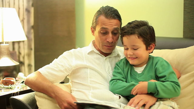 father and son reading a book
