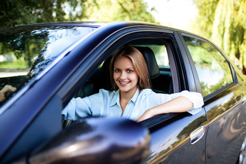 Young woman in her new car