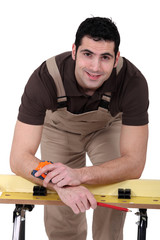 Man posing with his workbench