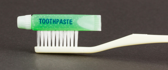 Toothbrush and green toothpaste isolated
