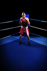 Male boxer in ring doing exercise